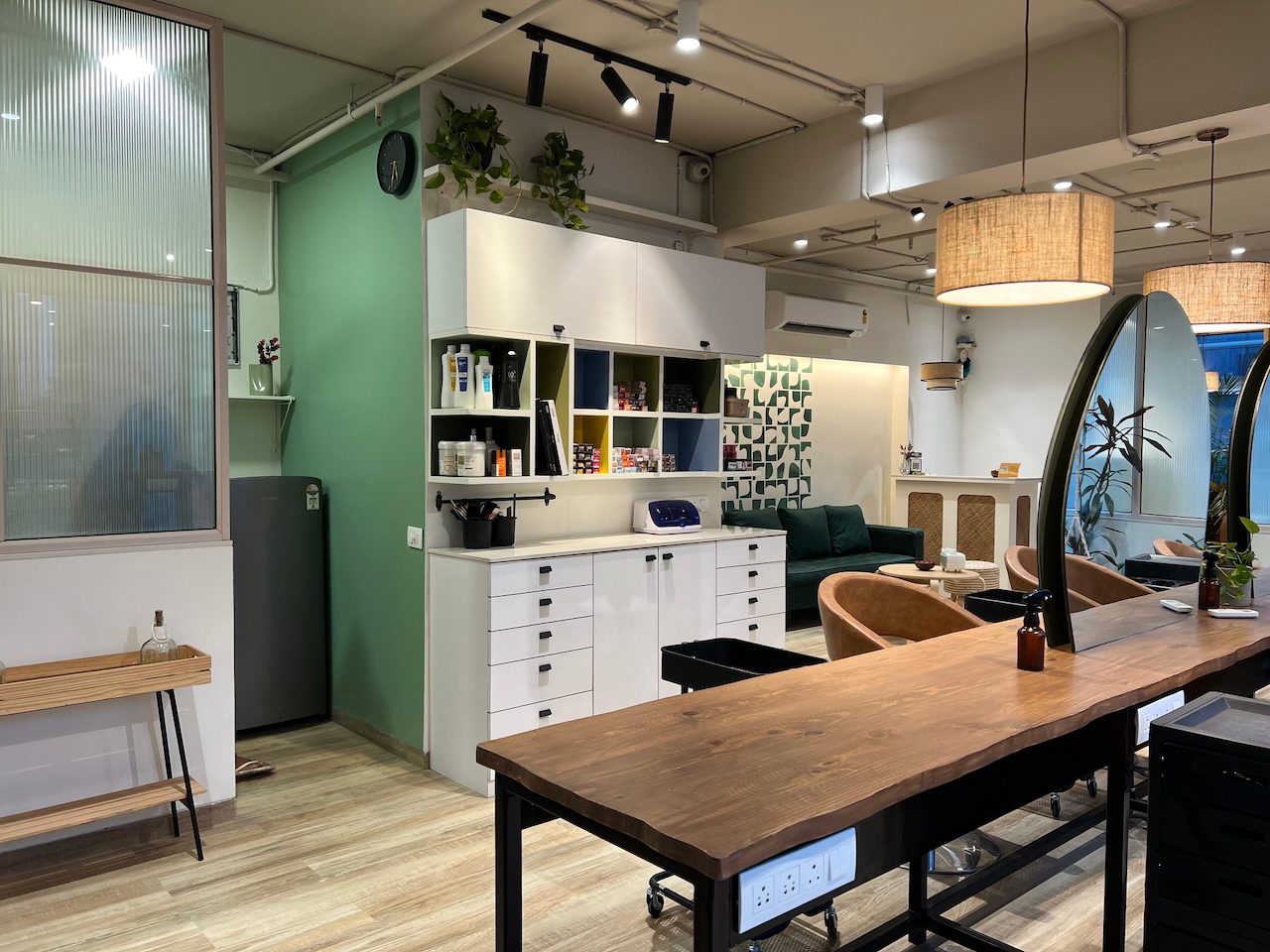 Product shelves and styling counter in front of the green wall