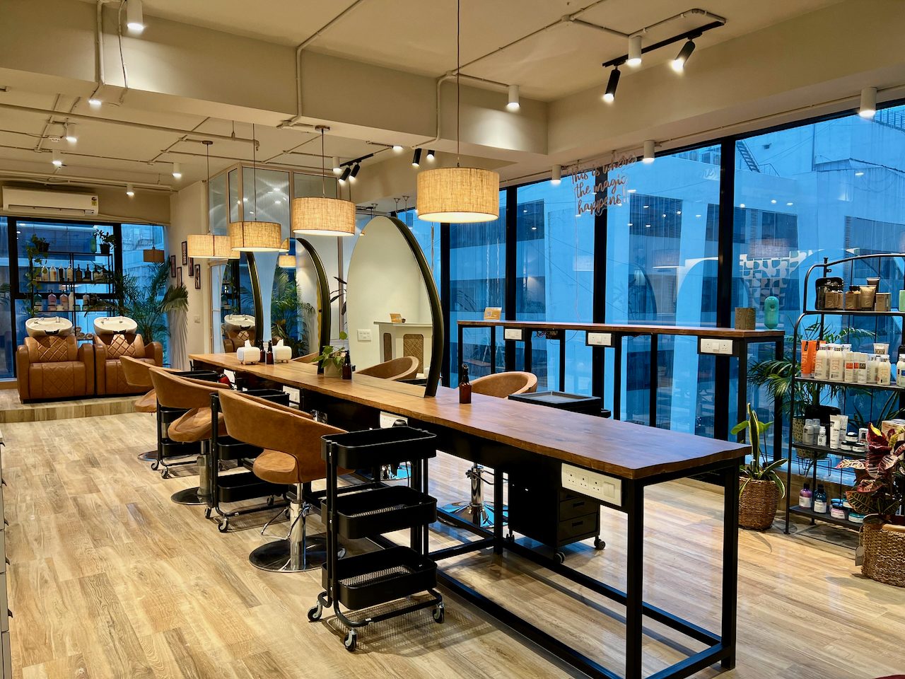 The styling floor at Misfits, a long walnut counter under full-height windows